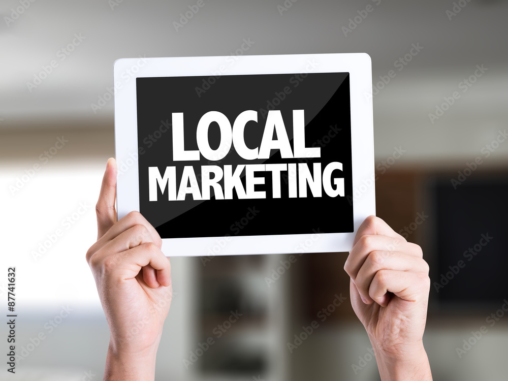 Tablet pc with text Local Marketing on a house background Tablet pc with text Local Marketing on a house background