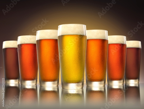 Fényképezés A tasty delicious row of a variety craft brew tap beers in pub glasses on reflec