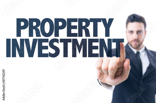 Business man pointing the text: Property Investment