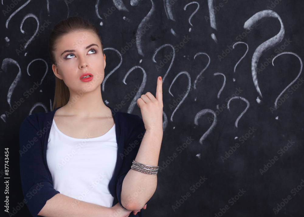Young girl with question mark on a gray background