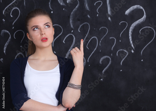 Young girl with question mark on a gray background