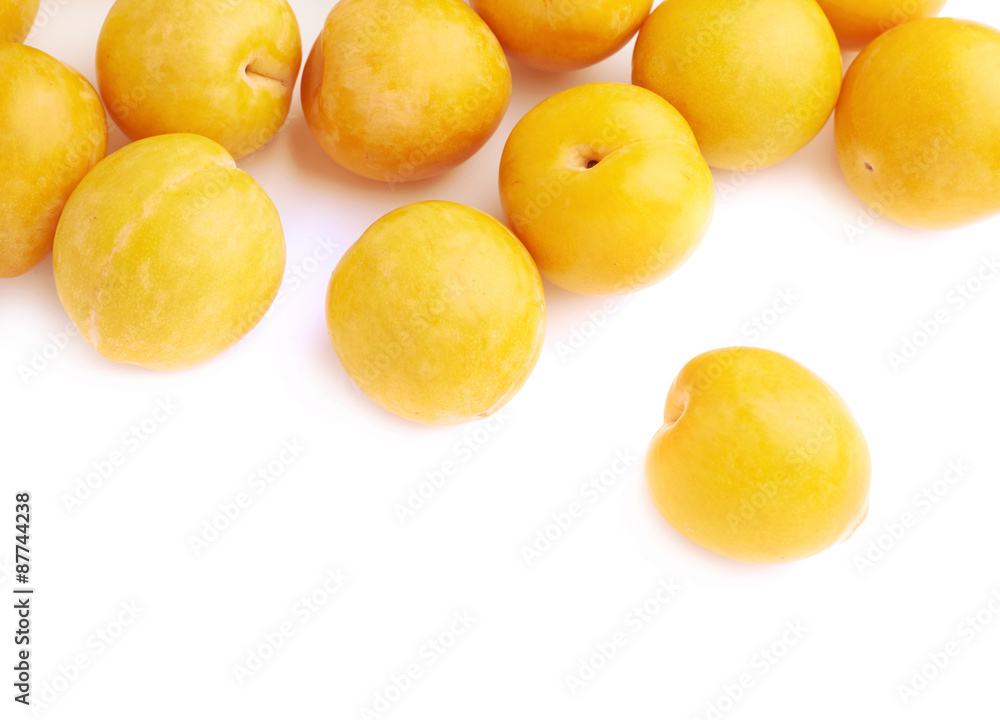 Pile of multiple yellow plums isolated