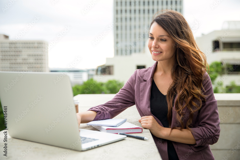Pretty business executive working from laptop computer lifestyle buildings office Pretty business executive working from laptop computer lifestyle buildings office