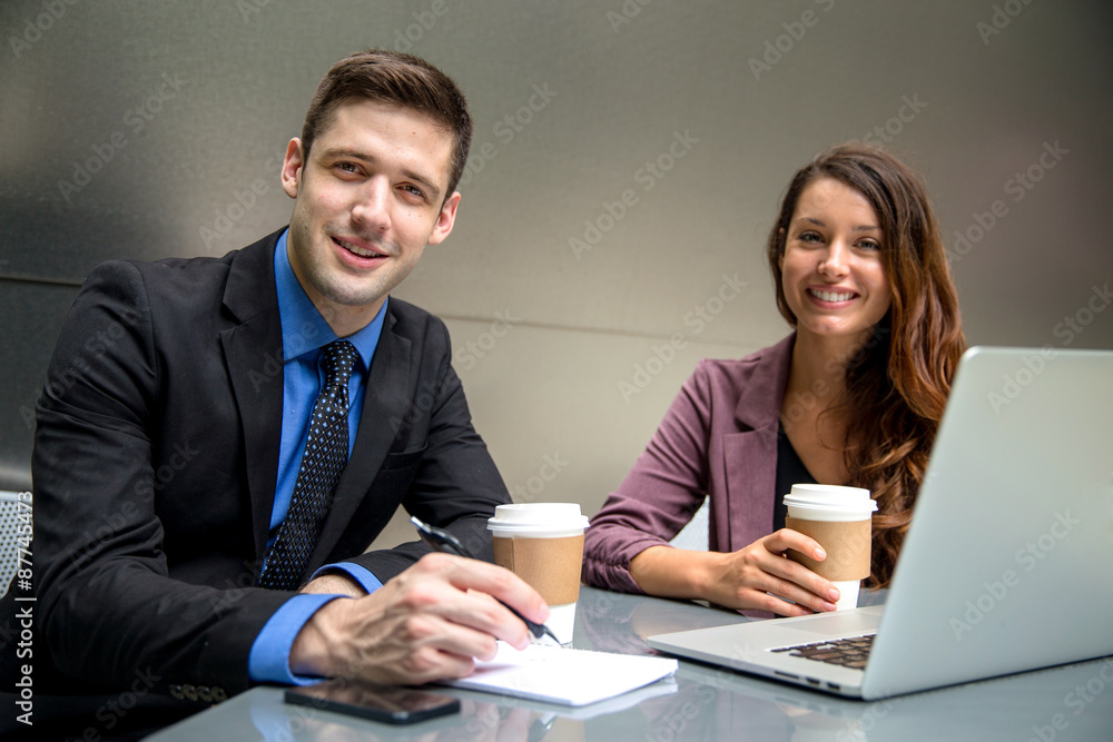 Handsome business man executive and pretty woman team colleagues at office workspace Handsome business man executive and pretty woman team colleagues at office workspace