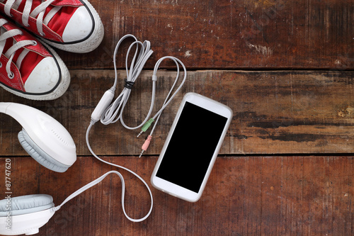 Outfit of traveler, student, teenager, young woman or guy. Overhead of essentials for modern young person. Different objects on wooden background.