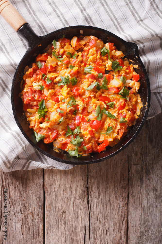 urkish breakfast: Menemen in the pan on the table. top view vertical urkish breakfast: Menemen in the pan on the table. top view vertical