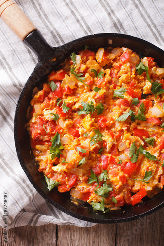 Omelette with vegetables in a pan close-up. top view vertical