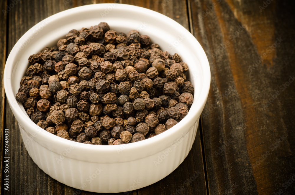 Black pepper in the bowl on wooden background,food ingredient Black pepper in the bowl on wooden background,food ingredient