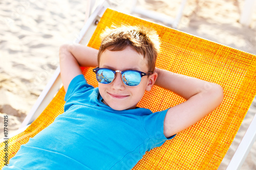 Little boy relax on deckchair photo