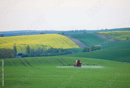 Tractor spraying fields