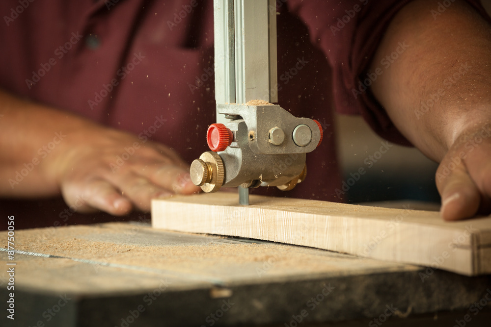 Professional carpenter working with sawing machine in workshop. Professional carpenter working with sawing machine in workshop.
