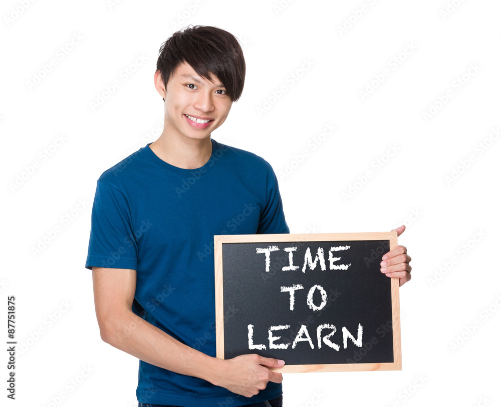 Asian man with the blackboard showing phrase of time to learn Asian man with the blackboard showing phrase of time to learn