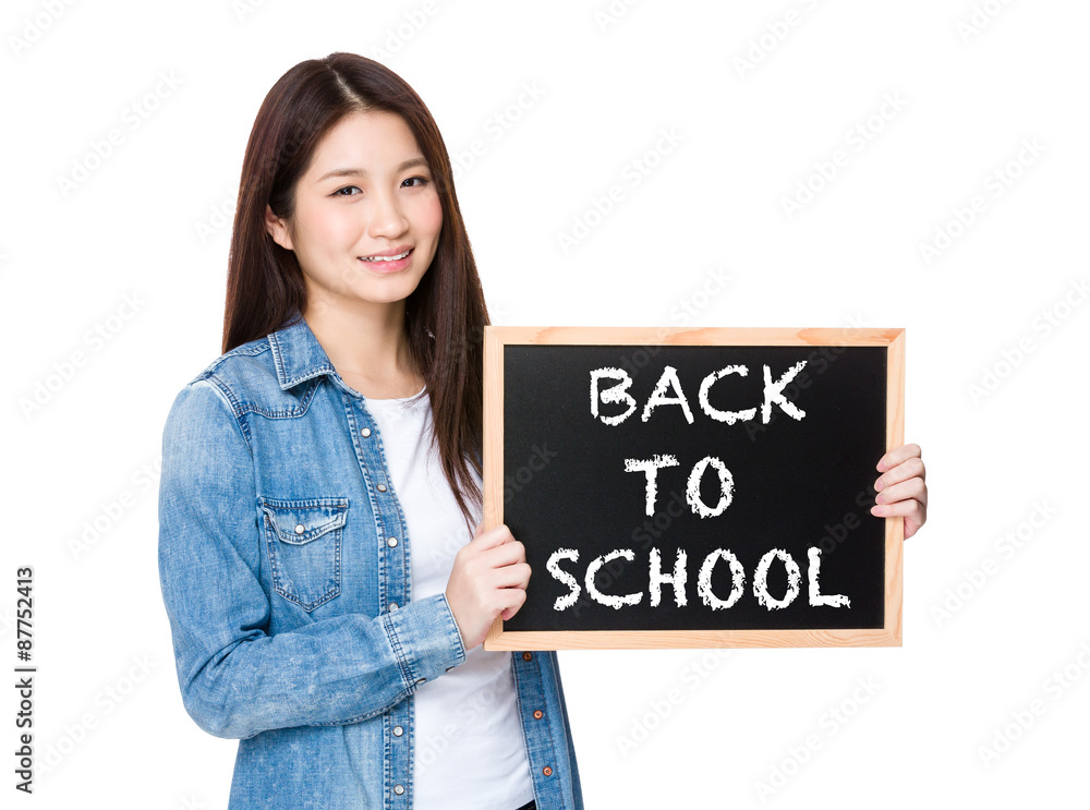 Woman with chalkboard showing phrase of back to school Woman with chalkboard showing phrase of back to school