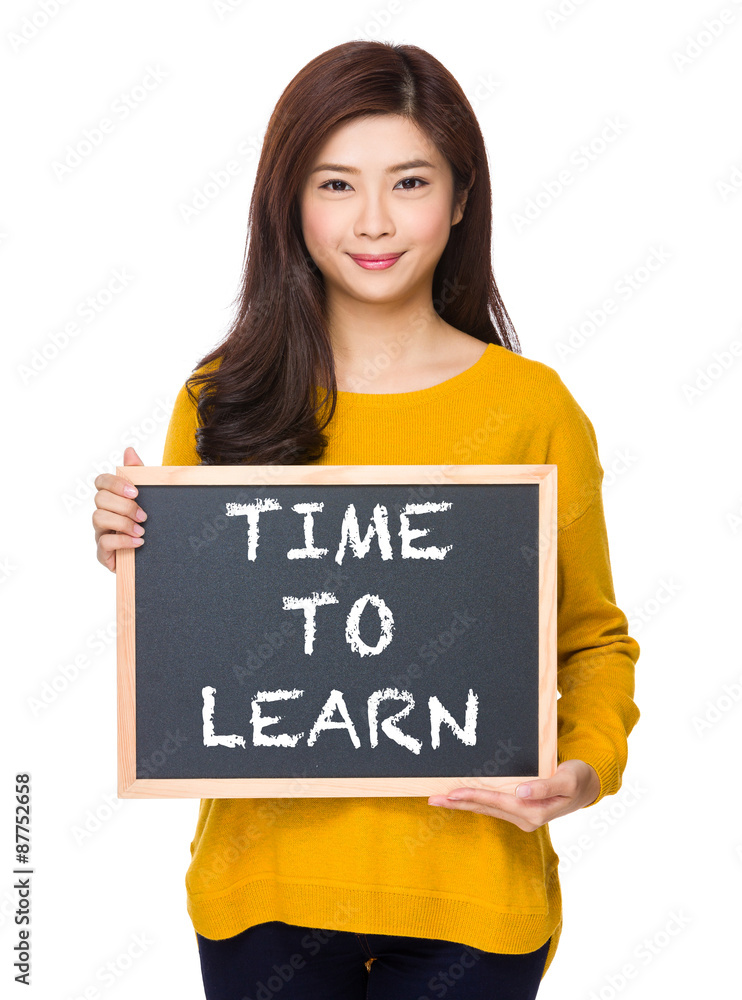 Woman with chalkboard showing phrase of time to learn Woman with chalkboard showing phrase of time to learn
