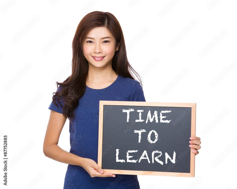Asian woman with blackboard showing phrase of time to learn Asian woman with blackboard showing phrase of time to learn