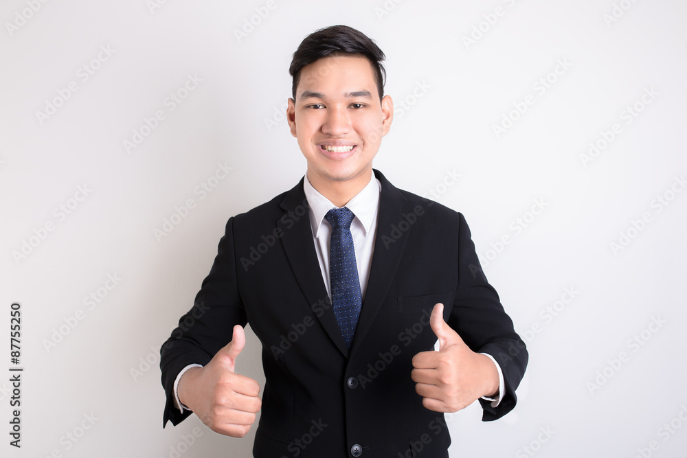 Portrait of the smiling man showing thumb up isolated on white b Portrait of the smiling man showing thumb up isolated on white b