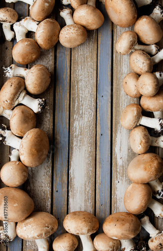 Portobello mushrooms on rustic wooden desk.