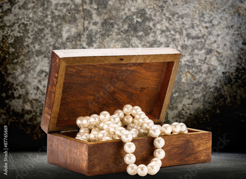 Wooden chest with white pearl necklace