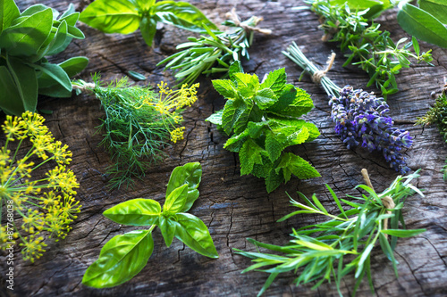 Foto Fresh herbs on wooden background