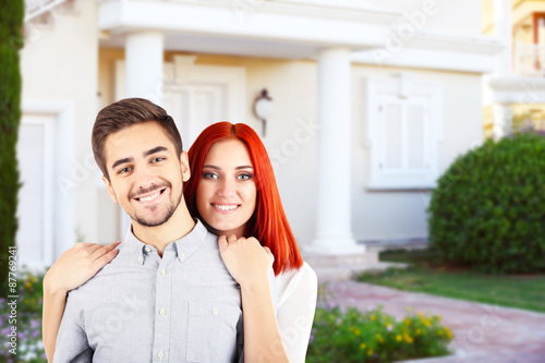 Loving couple near their house