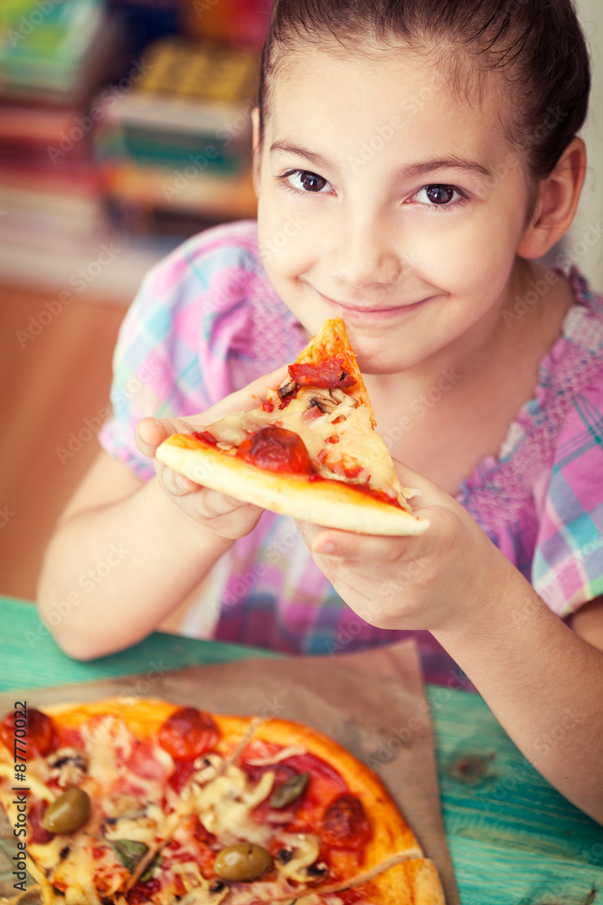 Beautiful Little girl eating pizza 