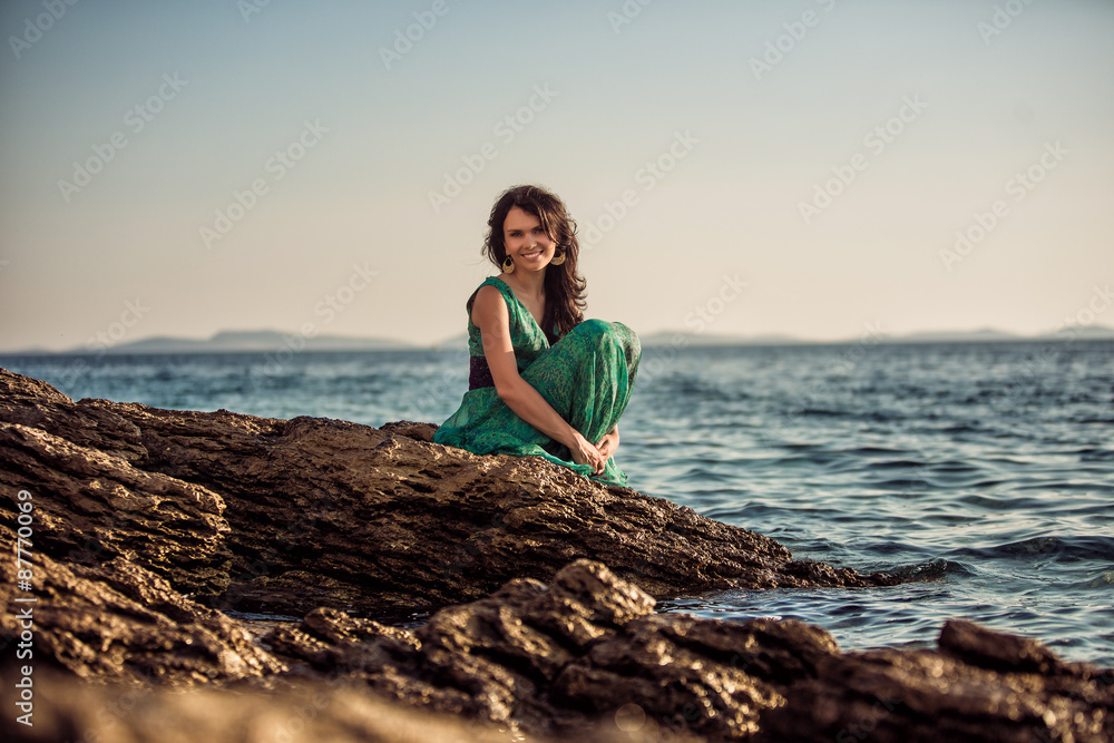 Portrait of a beautiful girl in the woods on the shore of the sea