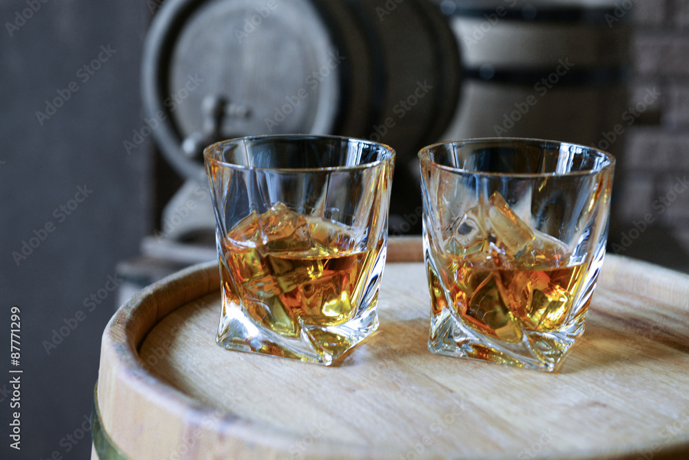 Glasses of brandy in cellar with old barrels Glasses of brandy in cellar with old barrels