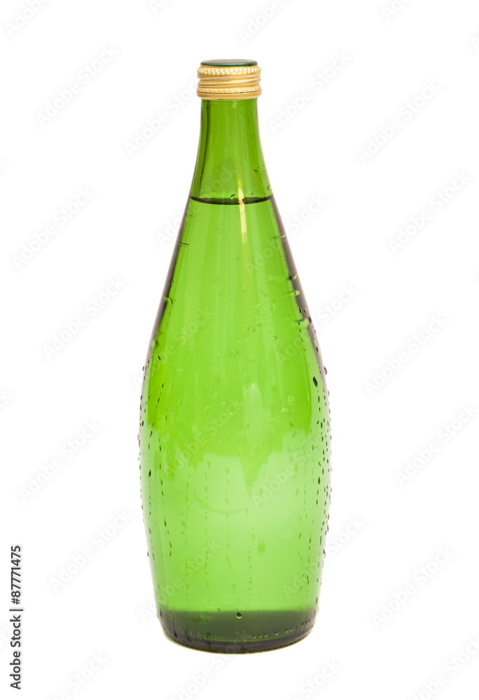 Glass bottle of soda water with water drops isolated on white ba Glass bottle of soda water with water drops isolated on white ba