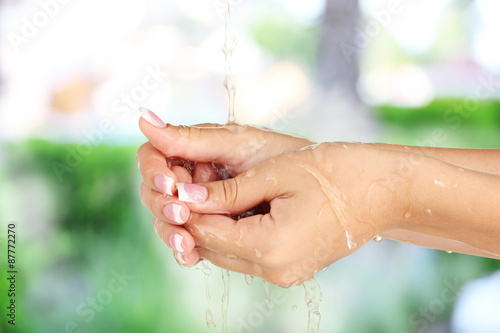 Washing hands on nature background