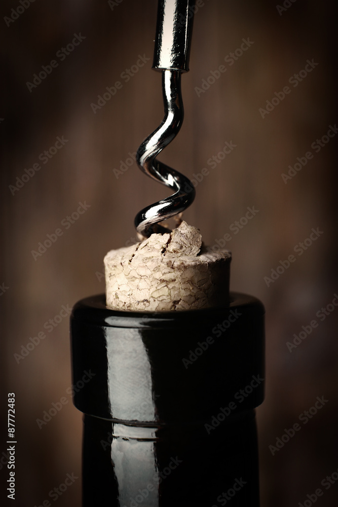 Bottle opener close-up, on wooden background Bottle opener close-up, on wooden background