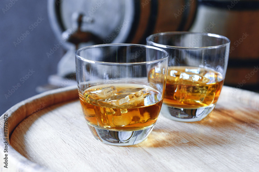 Glasses of brandy in cellar with old barrels Glasses of brandy in cellar with old barrels