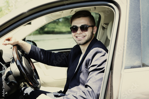 Young man in cabriolet © Africa Studio