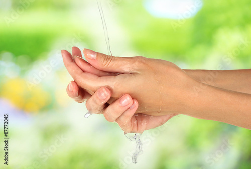 Washing hands on nature background