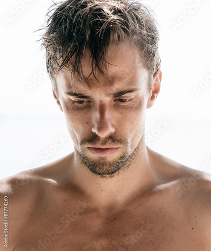 Serious young man with a goatee photo