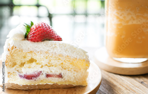 strawberry shortcake with ice milk tea, selective focus point on strawberry