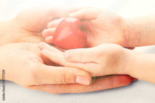 Fototapeta Naklejka Na Ścianę i Meble -  Heart in child and mother hands close up
