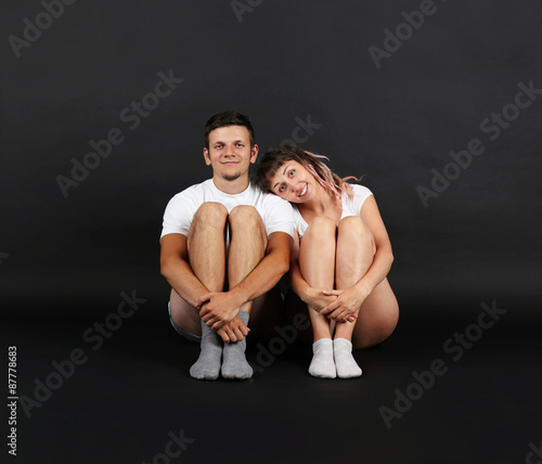 Young couple on black background