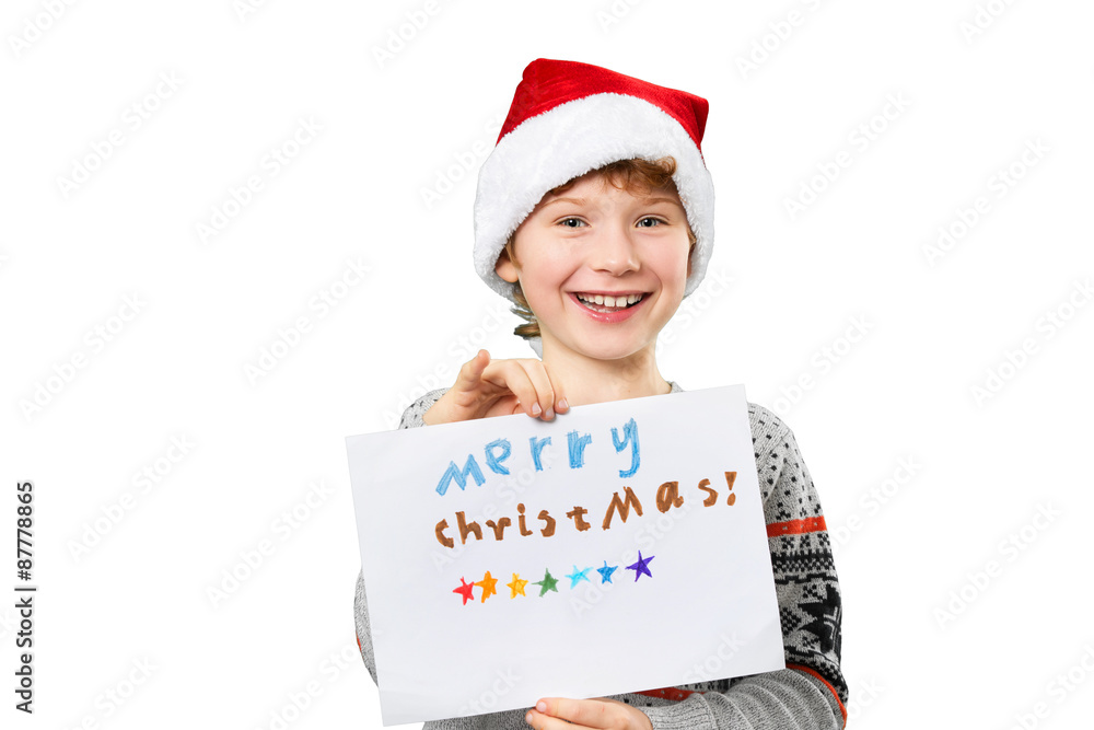 Portrait of a boy in christmas hat holding blank. Isolated