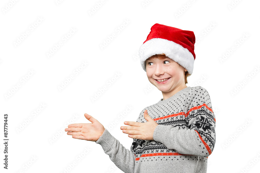 Portrait of a boy in christmas hat pointing at something with Portrait of a boy in christmas hat pointing at something with