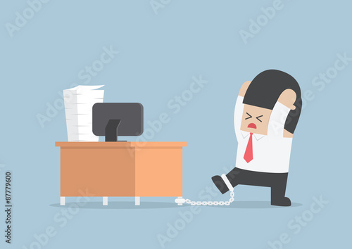 Businessman chained to the desk