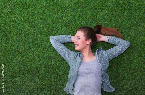 Relaxed woman  lying on the grass 