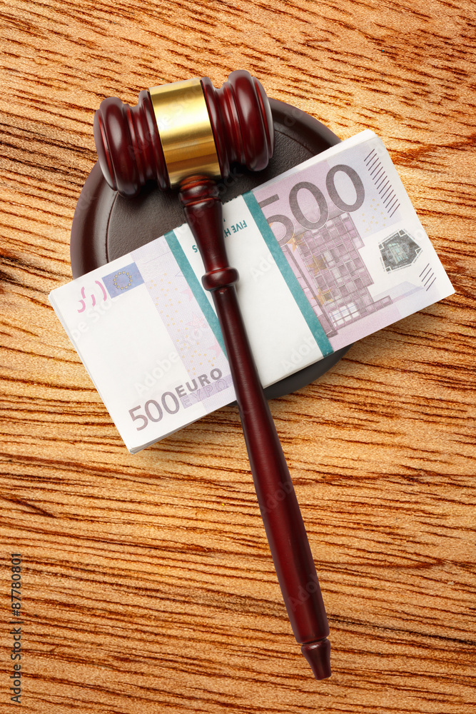 Wooden judge's gavel and money