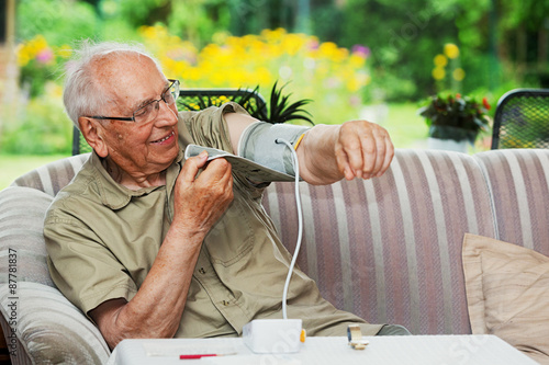 Elderly person with Sphygmomanometer photo