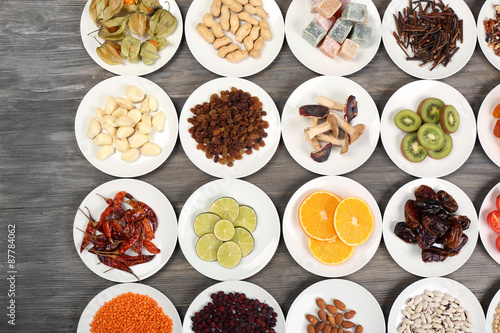 Different products on saucers on wooden table, top view © Africa Studio