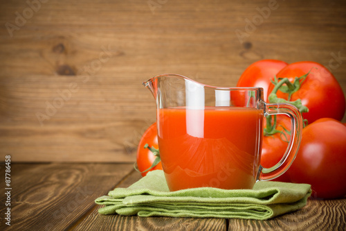 Jug with tomato juice photo