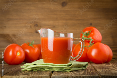 Jug with tomato juice photo