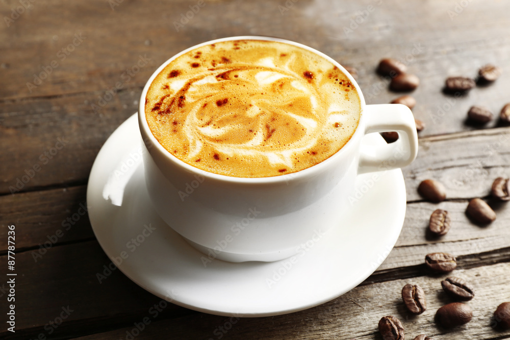 Cup of coffee latte art with grains and chocolate on wooden background Cup of coffee latte art with grains and chocolate on wooden background