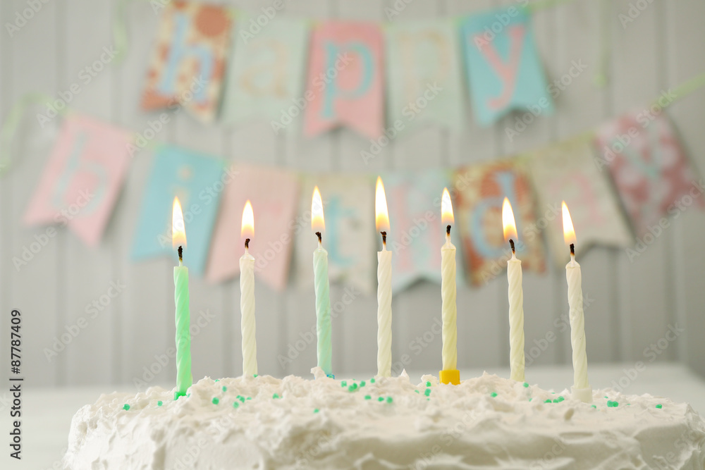 Birthday cake with candles on planks wall background Birthday cake with candles on planks wall background