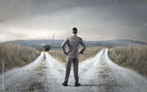 Undecided businessman weighing his choice photo