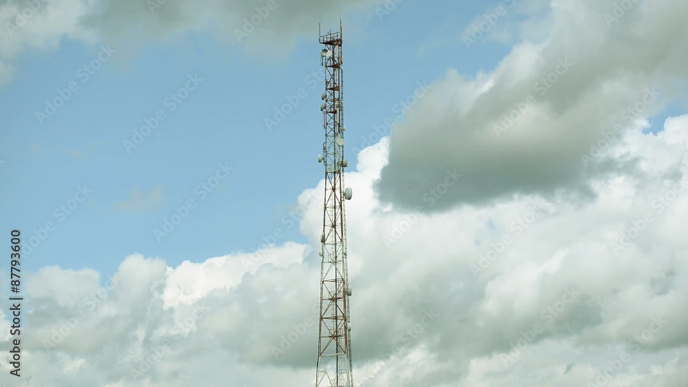 Telecommunication tower on the background of the cloudy sky Telecommunication tower on the background of the cloudy sky